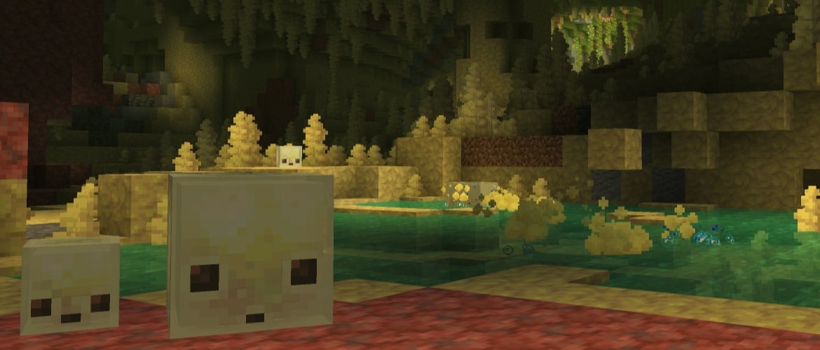 One big and one small Sulfur Cube standing inside a huge underground Sulfur Cave Biome with many Sulfur Spikes hanging from the ceiling.
