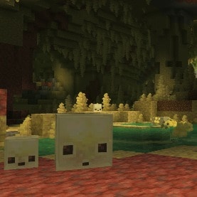 One big and one small Sulfur Cube standing inside a huge underground Sulfur Cave Biome with many Sulfur Spikes hanging from the ceiling.