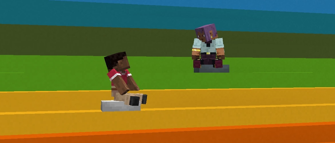 Efe and Zuri are looking each other while they are sitting on cushions on a concrete rainbow staircase.