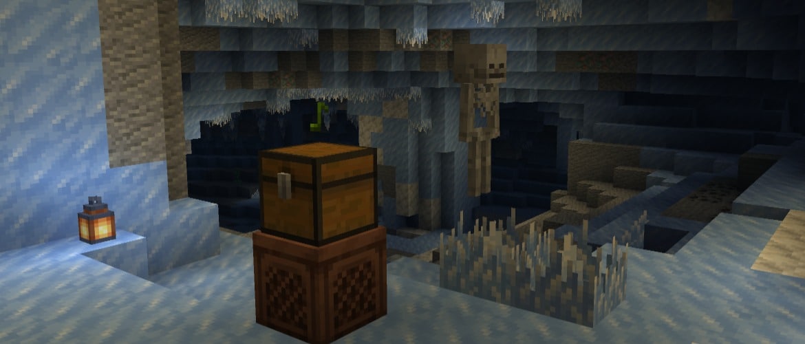 A chest on a jukebox in an ice cave and a skeleton in the background