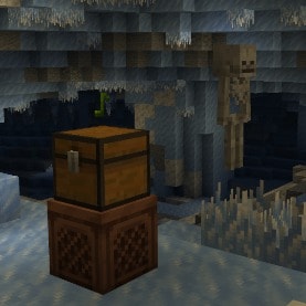 A chest on a jukebox in an ice cave and a skeleton in the background