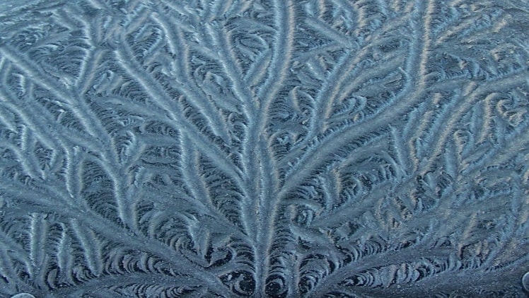 A photo of frozen water with crystallization.