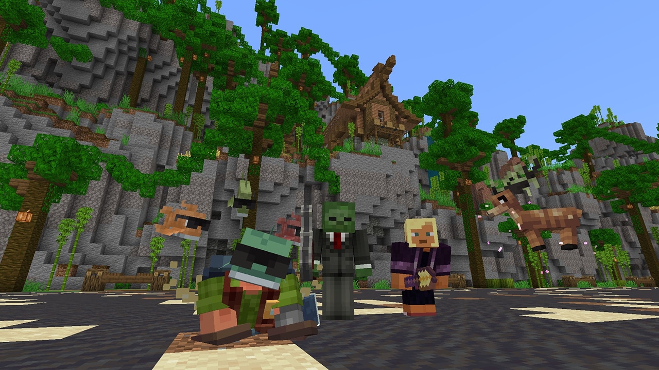 Three Minecraft players and several pets gather at the foot of a jungle-covered cliff, with a wooden house perched above.