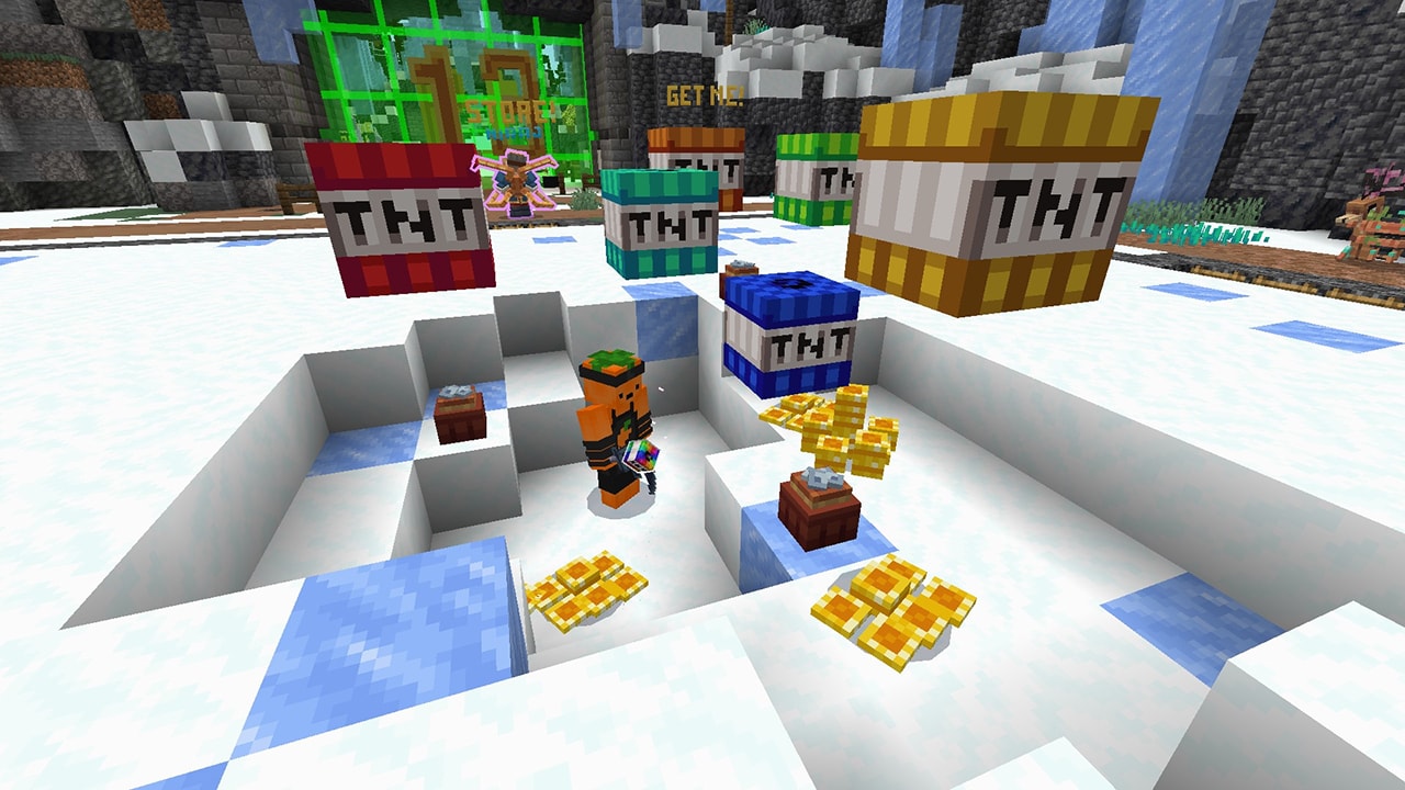 A player stands in a snowy excavation surrounded by colorful TNT blocks and piles of gold.