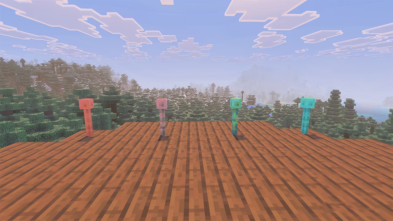 Four copper lightning rods of different oxidation stages stand on a wooden platform overlooking a forest and mountains under a cloudy sky.