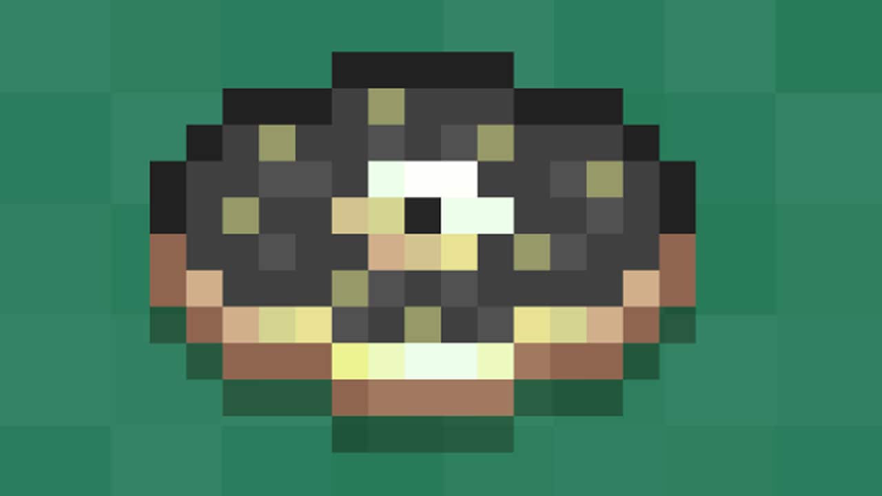 Close-up of a pixelated music disc on a green background.
