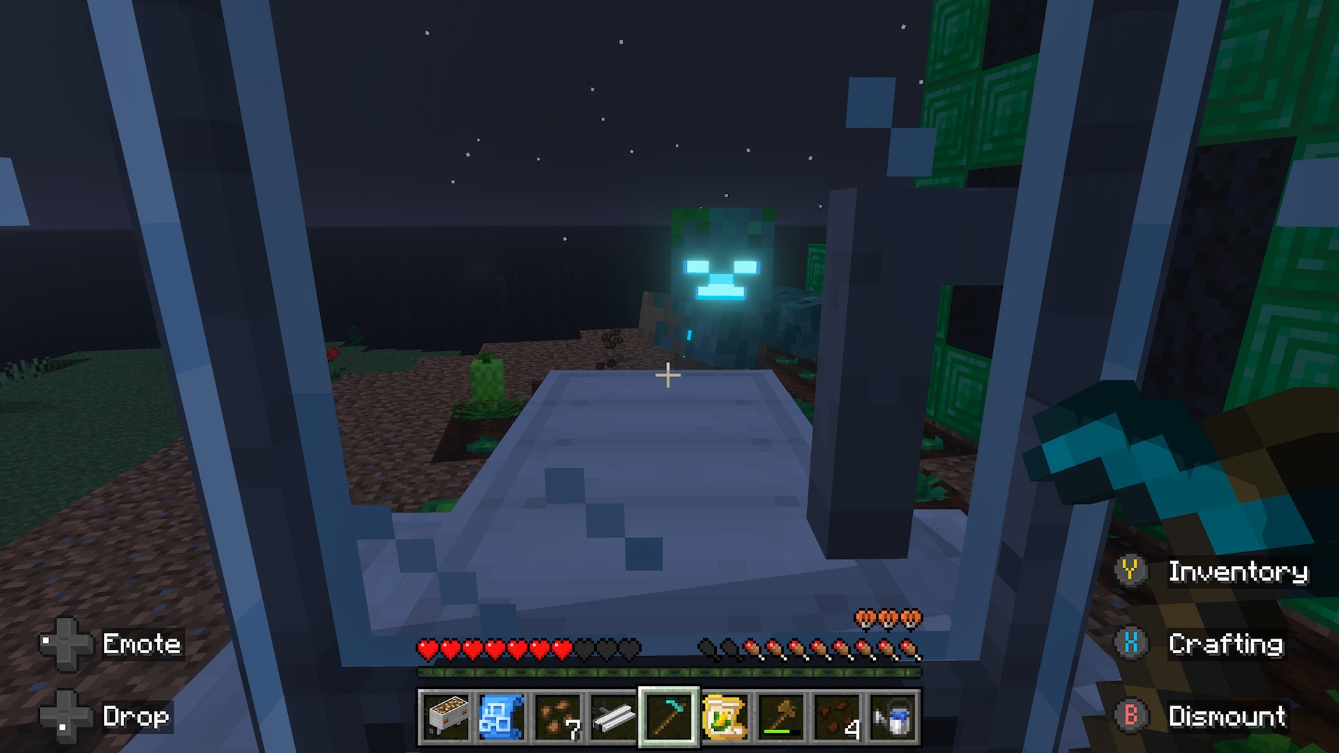 Viewed from inside a tractor at night, a player faces a glowing hostile mob near crops and a green block structure.