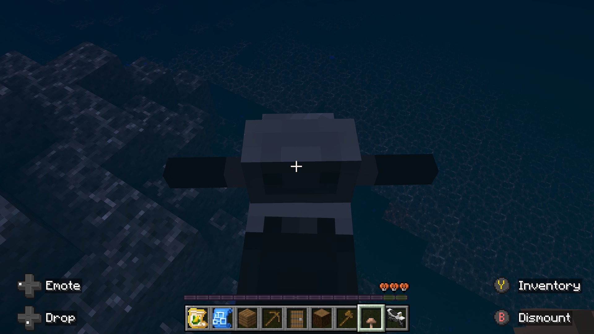 Top-down view of a small farming vehicle moving underwater near a rocky seabed in a dark ocean.