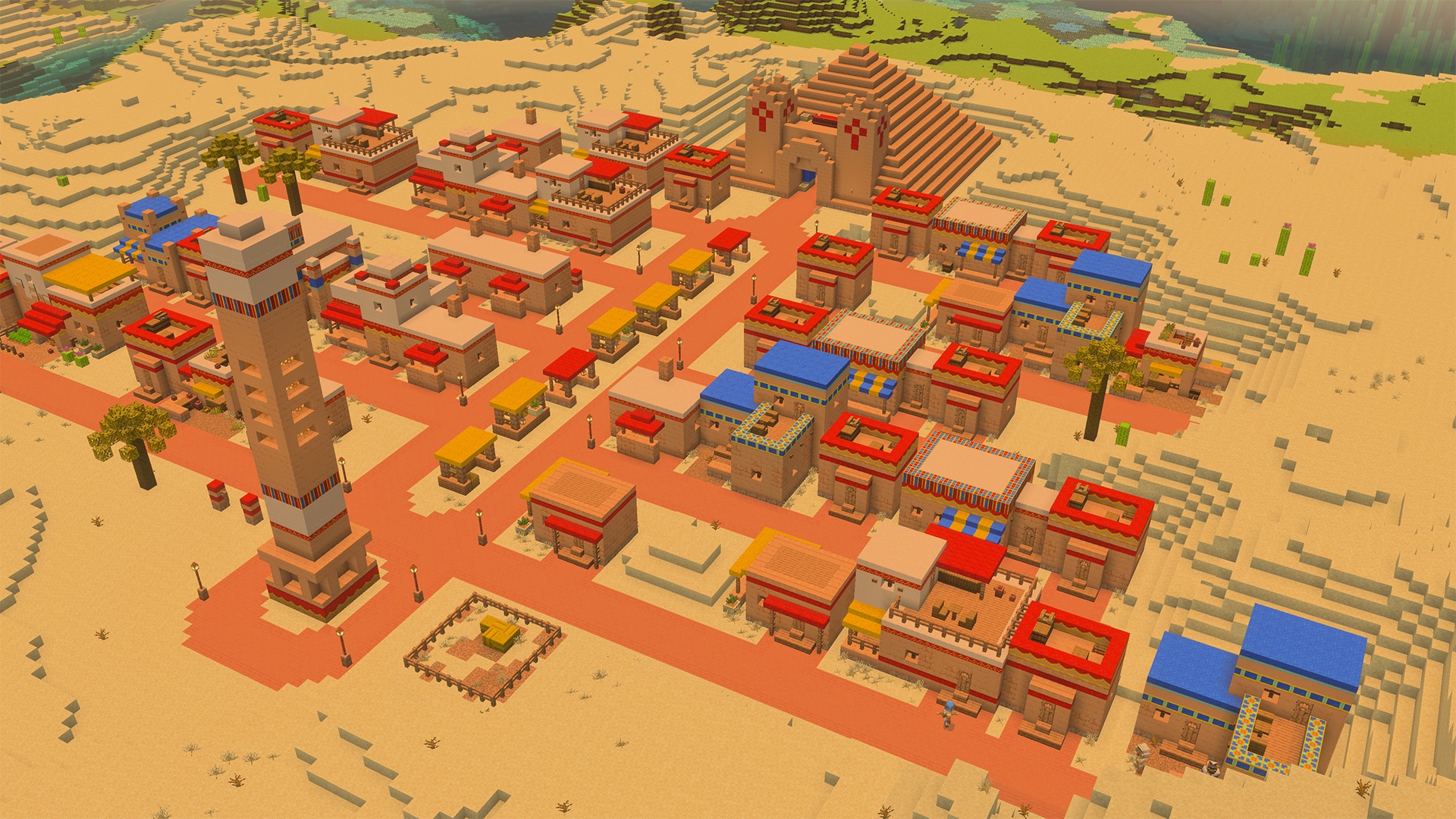 Aerial view of a sprawling desert settlement with sandstone buildings, colorful roofs, market stalls, roads, and a large pyramid.