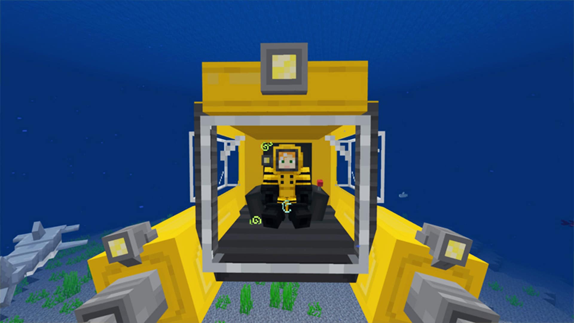 A player pilots a yellow submarine through a Minecraft ocean while dolphins swim nearby above seagrass and the sandy seafloor.