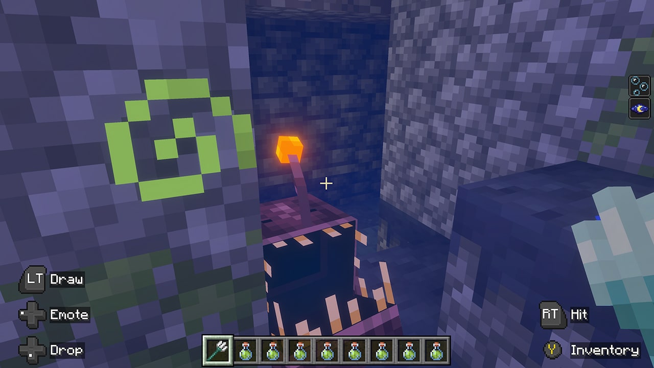 A small bioluminescent sea creature hides between stone blocks in an underwater structure, glowing with a bright orange lure.