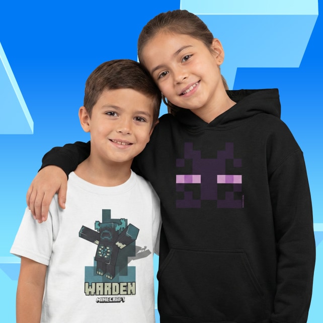 A boy wears a white t-shirt with a warden mob on it. A girl wears a black hoodie with an enderman face on it.
