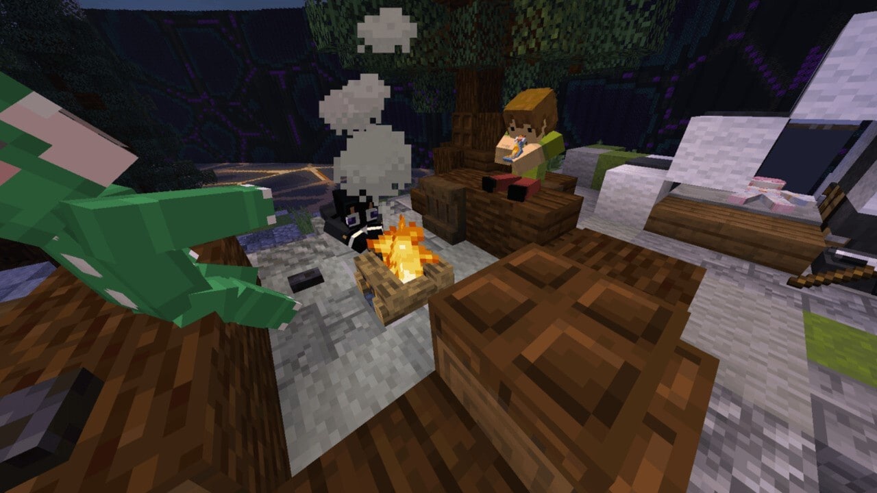 Three players sitting around a campfire in a snowy landscape.