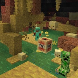 Noor pushing a TNT-absorbed Sulfur Cube towards a Creeper in Sulfur Cave Biome. In the background a couple of Sulfur Spike stalactites can be seen and couple of Sulfur Cubes jumping around.