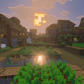 A Minecraft village at sunrise. There is a boat with a chest on some water in the foreground.