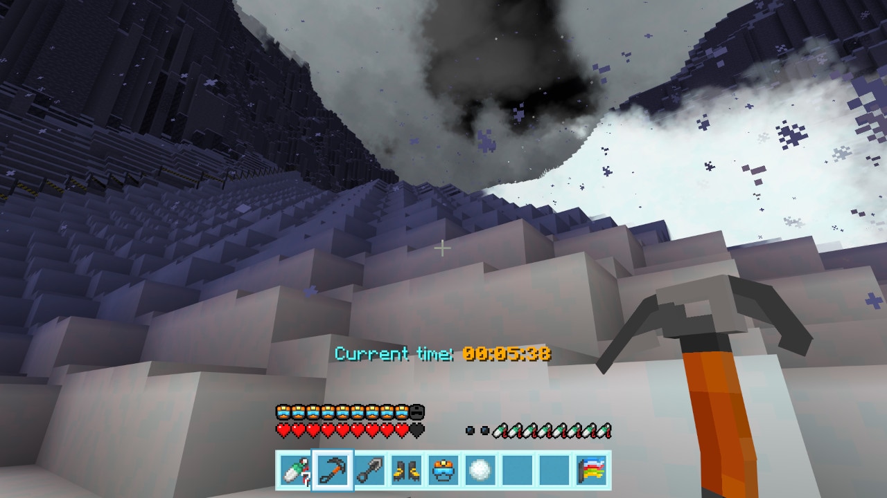 Steep snowy slope viewed from below during a storm, with swirling snow clouds and an ice pick in hand