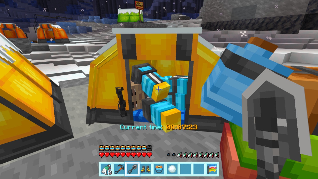 Close-up of a climber resting inside a yellow tent, surrounded by cold-weather gear and snow-covered ground