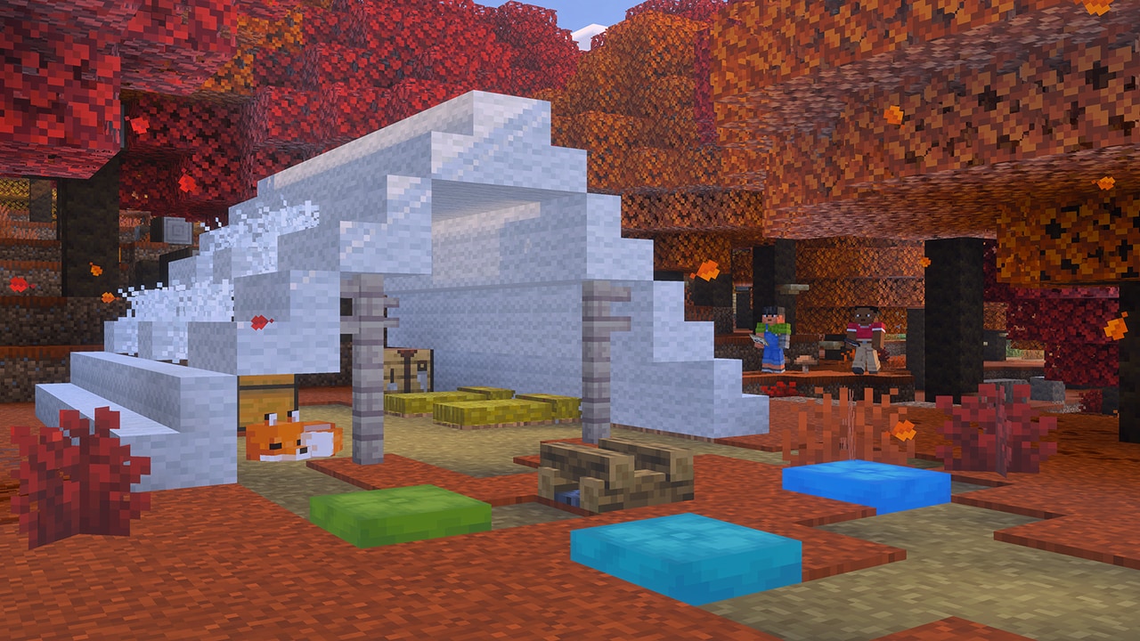 A white structure in the dappled forest has straw beds and a sleeping fox under it, with an unlit campfire and cushions beside it.