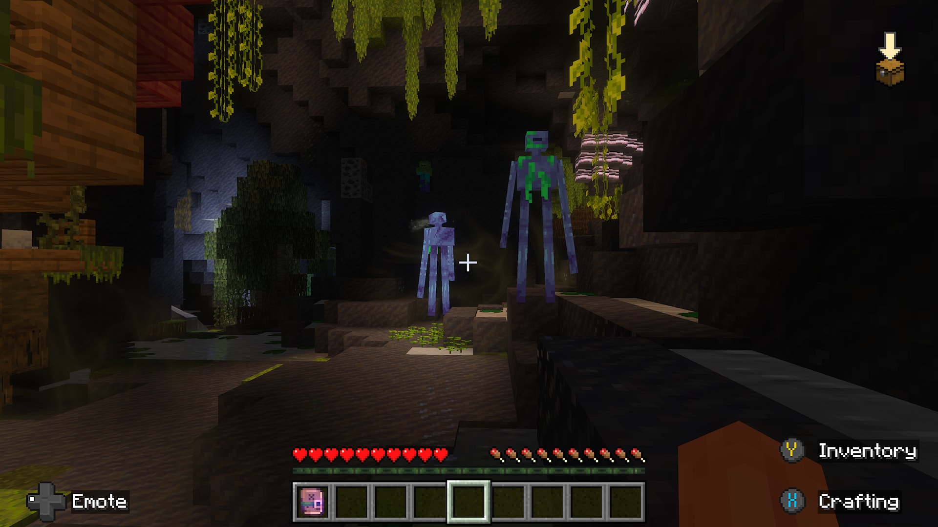 Minecraft player encounters tall green-and-purple humanoid creatures among hanging vines and vegetation in a dark cave.