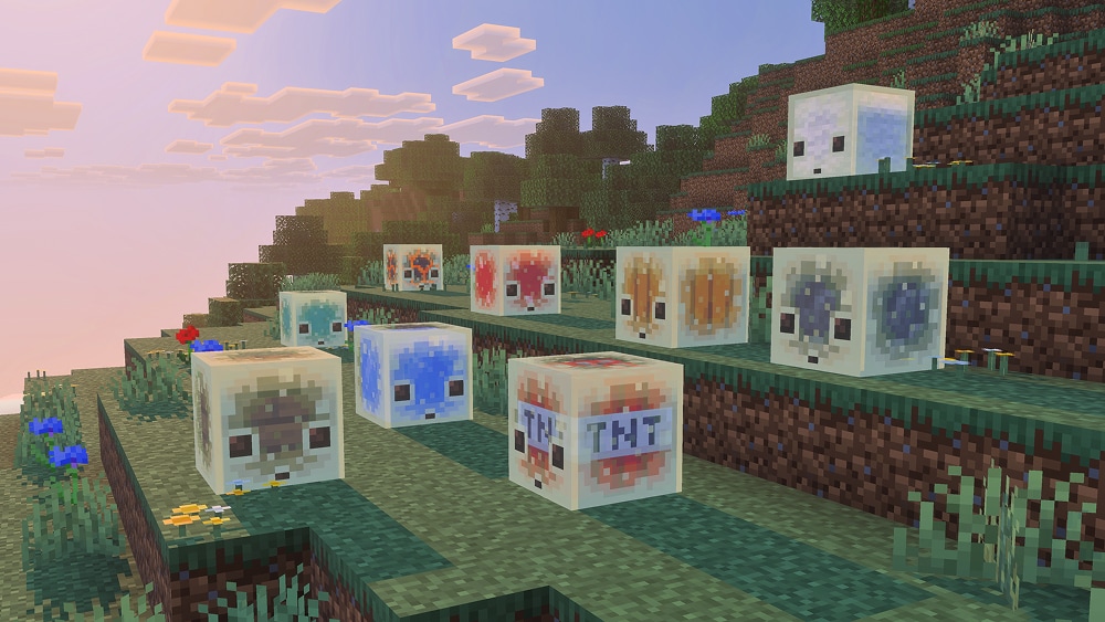 Nine sulfur cubes that have absorbed different block types, such as ice, lava, TNT, and others, are sitting on a grassy hillside.