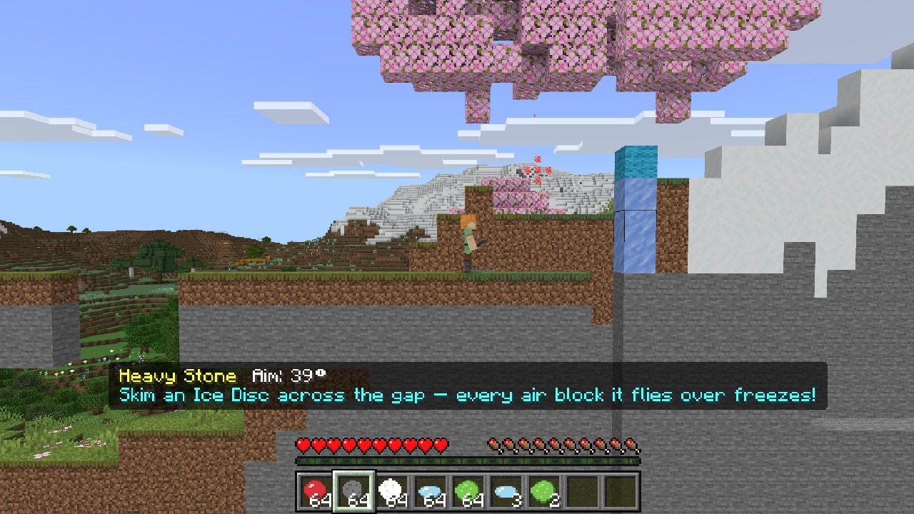 Player prepares an ice disc shot across a gap; frozen blocks create a path through a snowy Minecraft landscape.