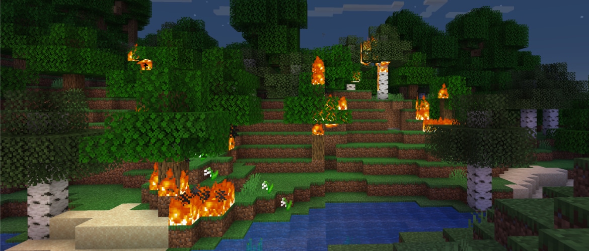Screenshot of a forest in Minecraft during night, with parts of it burning.